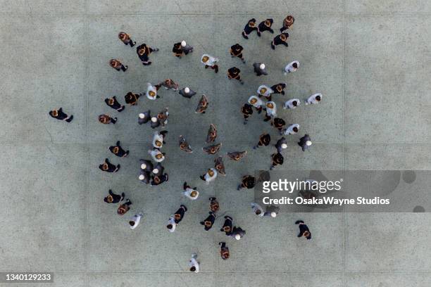 group of people standing on concrete floor - crowd of people from above stock pictures, royalty-free photos & images