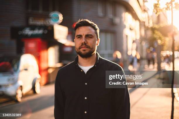 thoughtful man walking on street in city during summer - ukraine people stock pictures, royalty-free photos & images