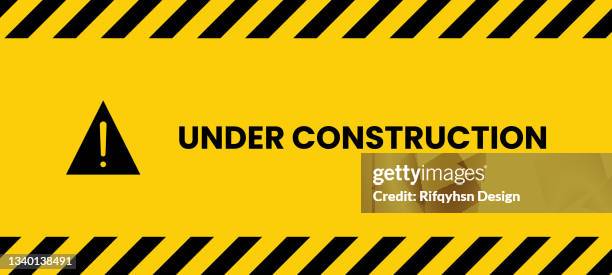 black and yellow under construction line striped rectangular background, yellow and black stripes on the diagonal - rough road surface stock illustrations