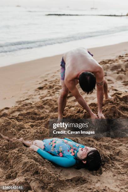 Father Hurries Daughter In The Sand On A Beach On Oahu Hawaii High-Res Stock Photo