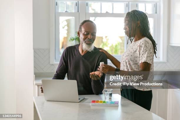 senior couple having online medical consultation with doctor telemedicine concept - taking medication stockfoto's en -beelden