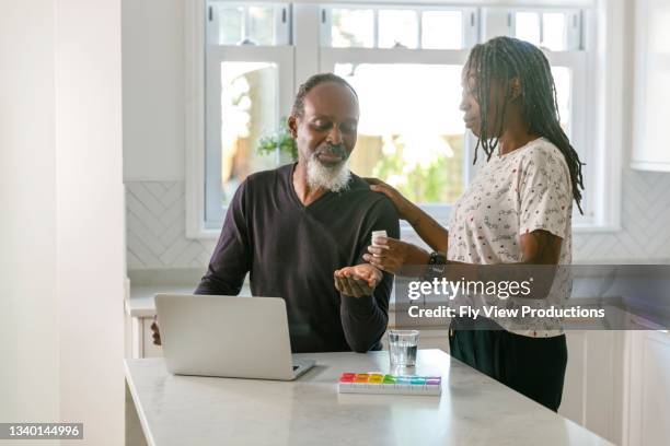 senior couple having online medical consultation with doctor telemedicine concept - pill organizer stock pictures, royalty-free photos & images