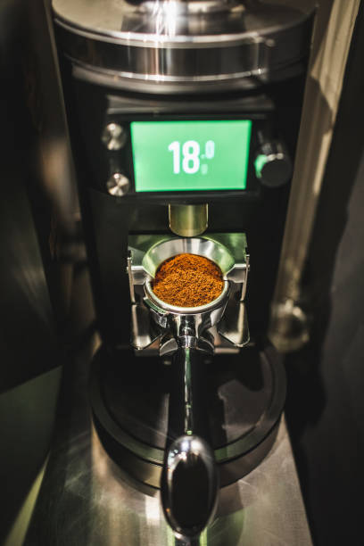 espresso size of ground coffee in filter holder made by automatic coffee grinder -  coffee grind size stock pictures, royalty-free photos & images