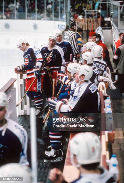 Athletes of the USA Men's Ice Hockey team sit in the bench area during a match against Sweden in the first round of the Ice Hockey tournament of the...