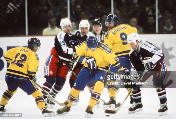 Hakan Loob, Petri Liimatainen, and Thomas Rundquist of Sweden, Sean Hill, and Scott Young of the United States play in the first round of the Ice...