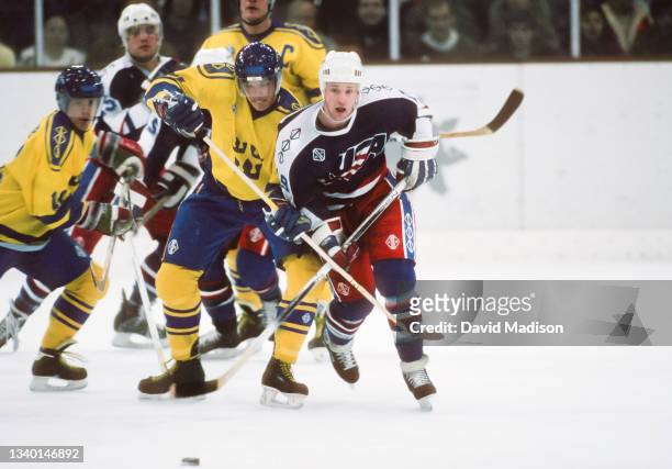 Hakan Loob and Carl Young of Sweden, and Scott Young of the United States play in the first round of the Ice Hockey tournament of the 1992 Winter...