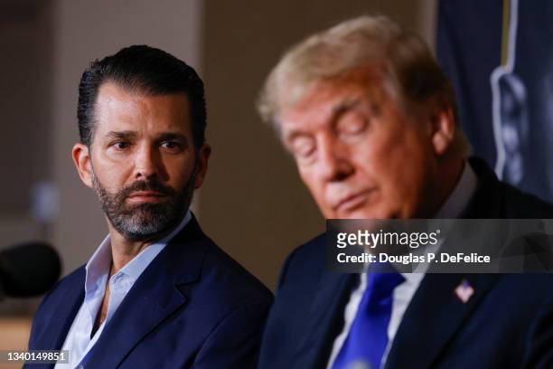 Donald Trump Jr. And former President of the United States Donald Trump look on prior to the fight between Evander Holyfield and Vitor Belfort during...