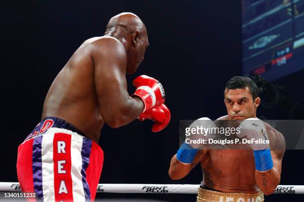 Vitor Belfort and Evander Holyfield square off to fight during the first round of the fight during Evander Holyfield vs. Vitor Belfort presented by...