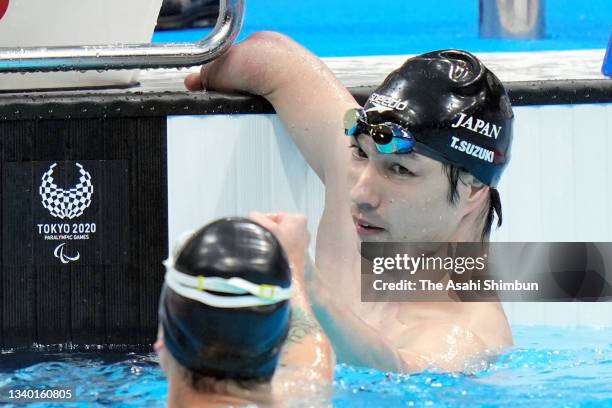 Takayuki Suzuki of Team Japan is congratulated after winning the bronze medal in the Swimming Men's 150m Individual Medley - SM4 on day 4 of the...