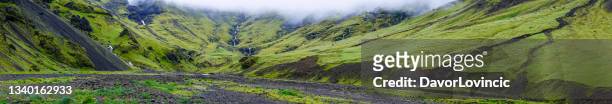 panorama landscape view partly with black land, grass, rapids and waterfalls, iceland. - iceland lava stock pictures, royalty-free photos & images