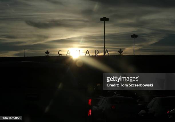 Cars line up at the Canadian border with the United States after getting off the Peace Bridge as the sun sets on September 8, 2013 in Buffalo, New...