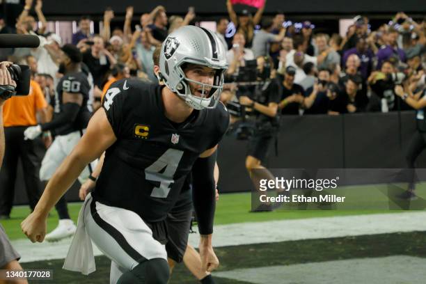 Quarterback Derek Carr of the Las Vegas Raiders celebrates after throwing a 31-yard touchdown pass to wide receiver Zay Jones in overtime to defeat...