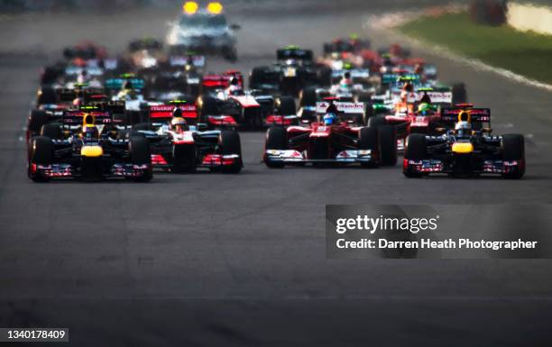 Australian Red Bull Racing Formula One team racing driver Mark Webber driving his RB8 racing car, British McLaren Formula One team racing driver...