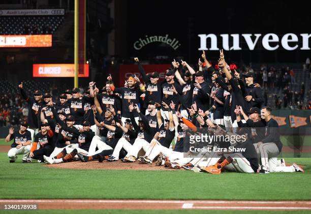 The San Francisco Giants pose for a team photo on the field after they clinched a playoff birth by beating the San Diego Padres at Oracle Park on...