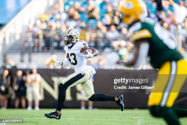 Marcus Williams of the New Orleans Saints runs for yardage after intercepting a pass from Aaron Rodgers of the Green Bay Packers during the third...