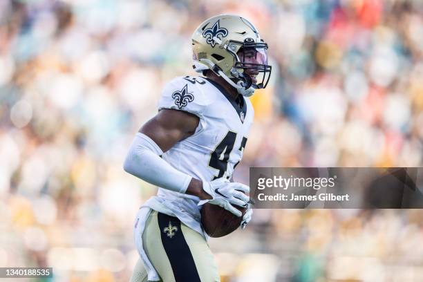Marcus Williams of the New Orleans Saints heads to the sideline after intercepting a pass from Aaron Rodgers of the Green Bay Packers during the...