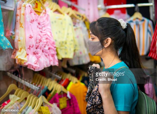 young woman enjoying weekend shopping in market. - delhi street stock pictures, royalty-free photos & images