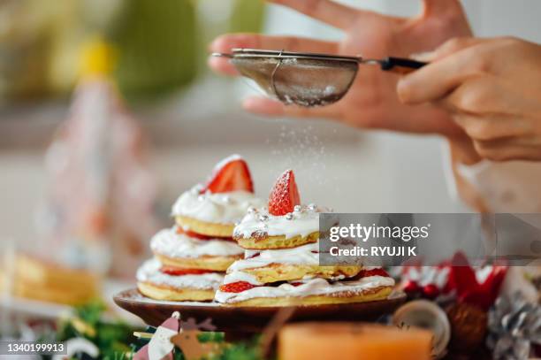 japanese young sister decorating a christmas cake together - christmas cake bildbanksfoton och bilder