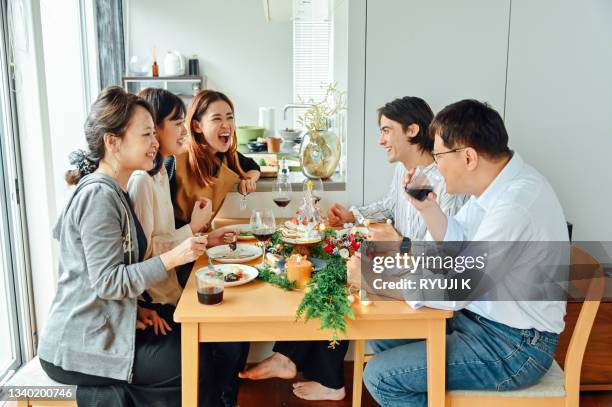 modern asian family christmas dinner - east asia stock pictures, royalty-free photos & images