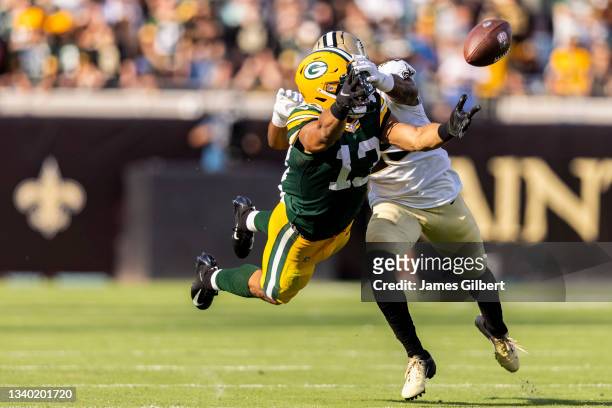 Allen Lazard of the Green Bay Packers dives for a pass against Paulson Adebo of the New Orleans Saints during the first half of a game at TIAA Bank...