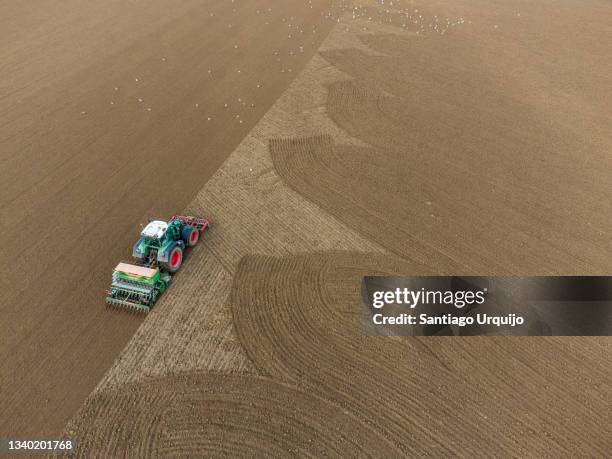 aerial view of tractor sowing an agricultural field - belgium aerial stock pictures, royalty-free photos & images