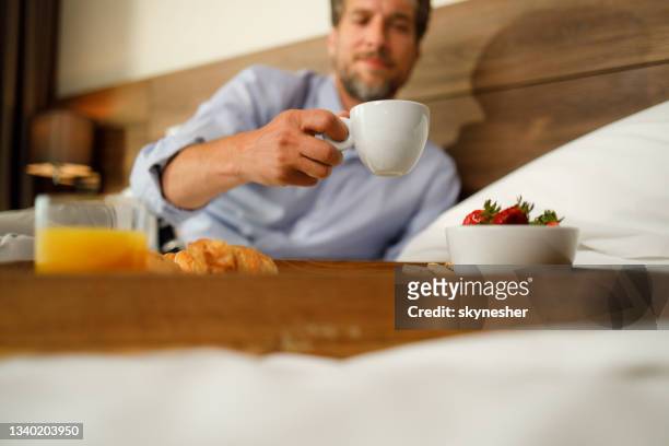 close up of a man taking coffee cup from a tray. - hotel breakfast bildbanksfoton och bilder
