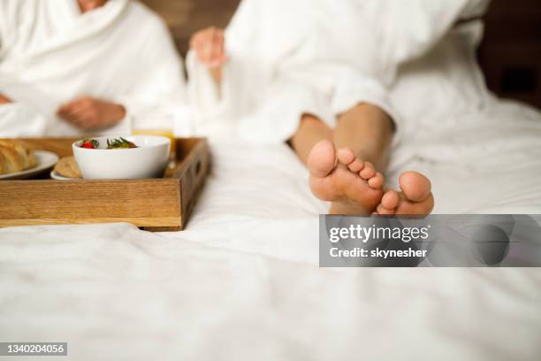 close up of woman's feet on a bed in bedroom. - couple breakfast bildbanksfoton och bilder