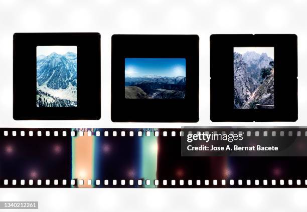 close-up of photographic slides and color negative 35mm film stripes on a white background. - diapositiva fotografías e imágenes de stock