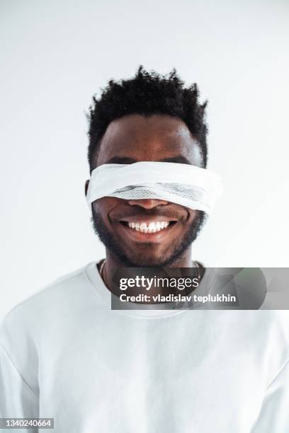 african american smiling with blindfold - blinddoek stockfoto's en -beelden