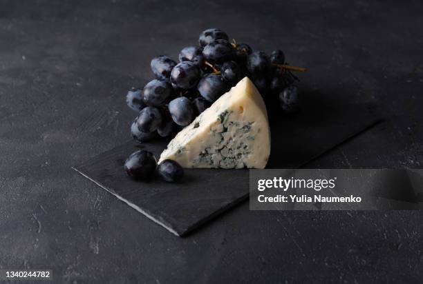 grapes with blue cheese on dark - roquefort cheese ストックフォトと画像