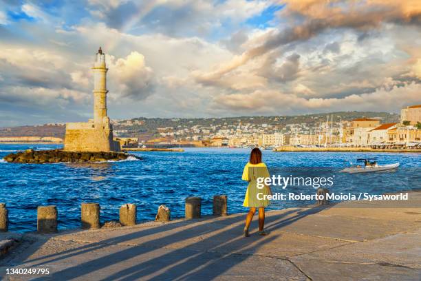 beautiful woman admiring the lighthouse, chania, crete - crete woman stock pictures, royalty-free photos & images