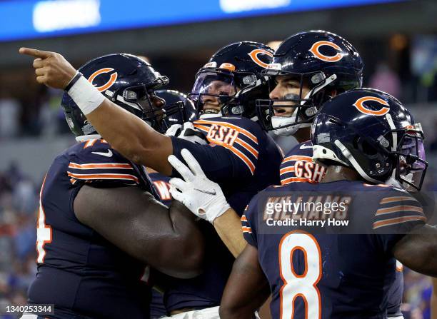 Justin Fields of the Chicago Bears celebrates his touchdown with Germain Ifedi and Cole Kmet to trail 20-14 during a 34-14 loss to the Los Angeles...