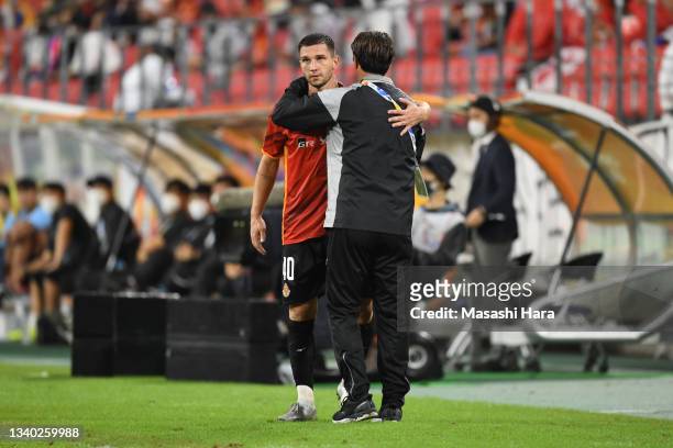 Jakub Swierczok and Massimo Ficcadenti of Nagoya Grampus hug during the AFC Champions League round of 16 match between Nagoya Grampus and Daegu FC at...