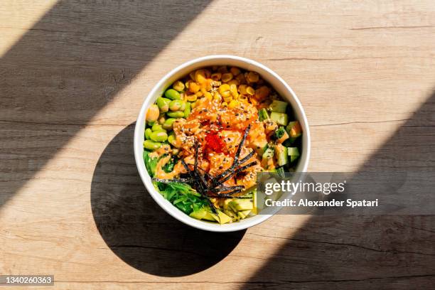 poke bowl with salmon, directly above view - essen tisch stock-fotos und bilder