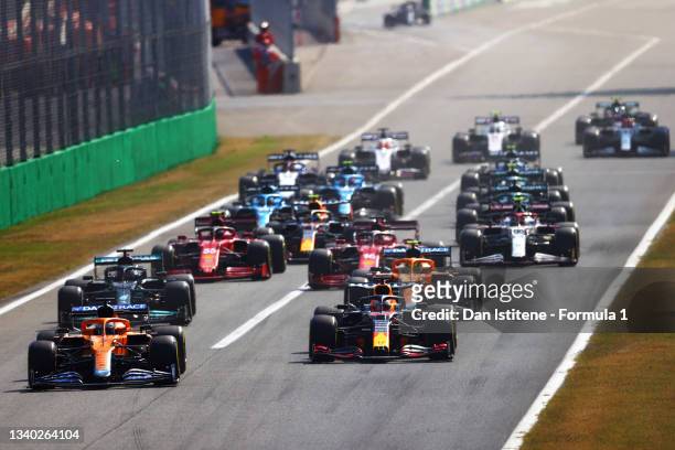 Daniel Ricciardo of Australia driving the McLaren F1 Team MCL35M Mercedes leads Max Verstappen of the Netherlands driving the Red Bull Racing RB16B...