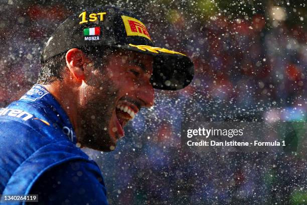 Daniel Ricciardo of Australia and McLaren celebrates on the podium after winning the F1 Grand Prix of Italy at Autodromo di Monza on September 12,...