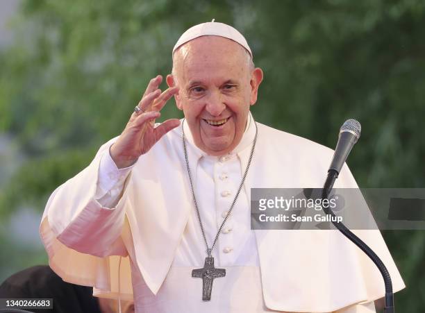 Pope Francis waves to onlookers and pilgrims while visiting the predominantly-Roma Lunik IX city district during his visit to eastern Slovakia on...