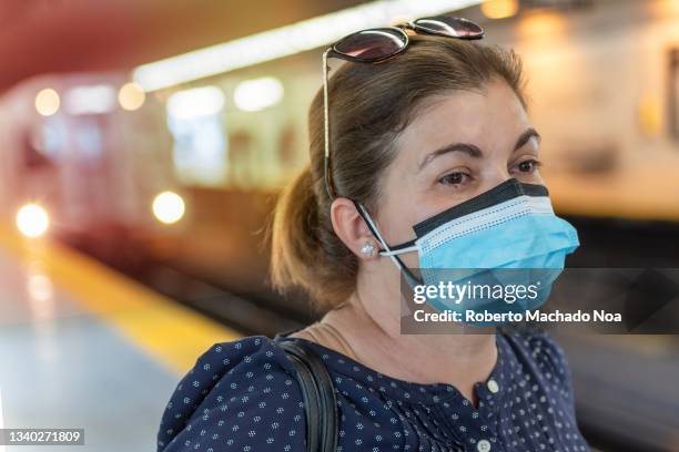 woman with double mask taking the subway - toronto subway stock pictures, royalty-free photos & images