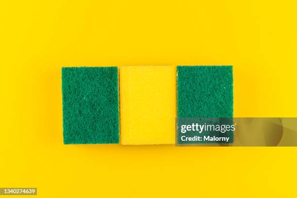 yellow kitchen sponges on yellow background. - brillos stockfoto's en -beelden