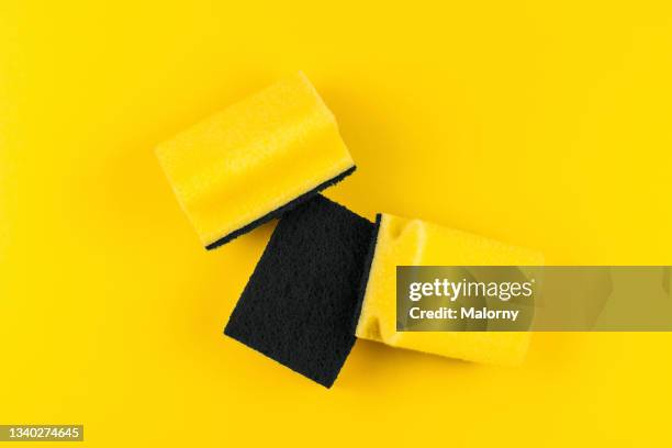 yellow kitchen sponges on yellow background. - scouring pad stock pictures, royalty-free photos & images