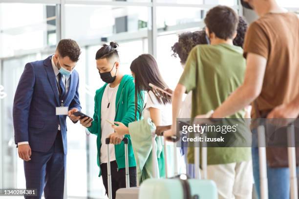 travelers during boarding at the airport - airport mask stock pictures, royalty-free photos & images