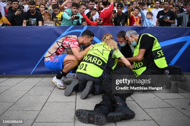 Security guard lies injured after a shot taken from Cristiano Ronaldo of Manchester United during the warm up makes contact with him during the UEFA...