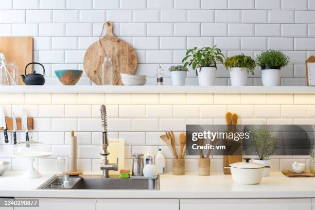 modern new light kitchen interior with utensils, decoration and pots with herbs - organised shelves imagens e fotografias de stock