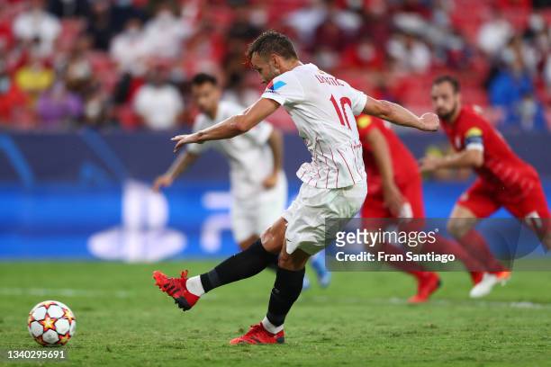 Ivan Rakitic of Sevilla FC scores their team's first goal from a penalty during the UEFA Champions League group G match between Sevilla FC and RB...