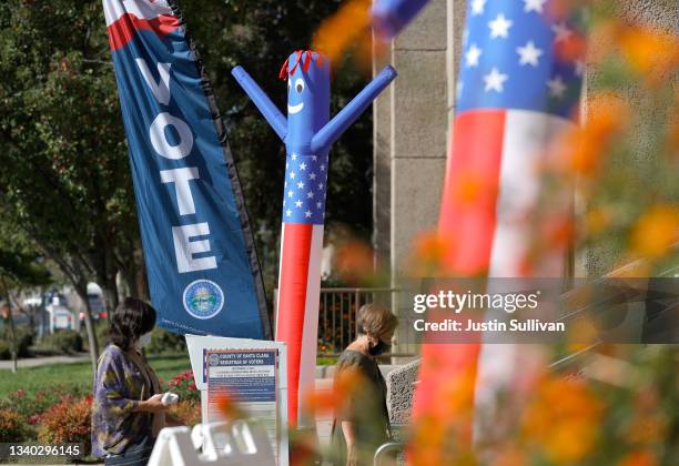 Voters arrive to cast their ballots in the California recall election at the Santa Clara County registrar of voters office on September 14, 2021 in...