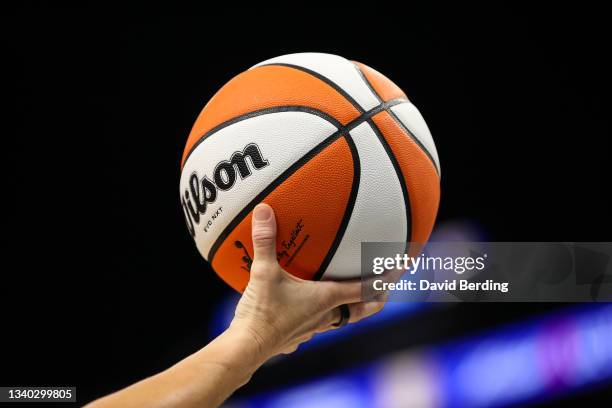 Referee holds the ball in the first half of the game between the Los Angeles Sparks and Minnesota Lynx at Target Center on September 2, 2021 in...