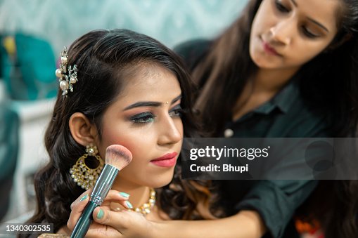 Beautiful Indian woman getting ready to a wedding reception at the beauty parlor. Beautiful Indian woman getting ready to a wedding reception at the beauty parlor.