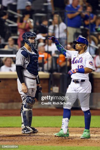 Francisco Lindor of the New York Mets gestures after he hit a home run as catcher Gary Sanchez of the New York Yankees looks on during the eighth...