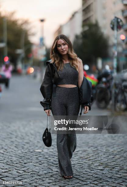 Sonny Loops wearing a black leather jacket, grey two piece and a black prada mini bag on September 11, 2021 in Berlin, Germany.
