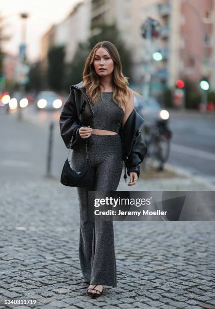 Sonny Loops wearing a black leather jacket, grey two piece and a black prada mini bag on September 11, 2021 in Berlin, Germany.